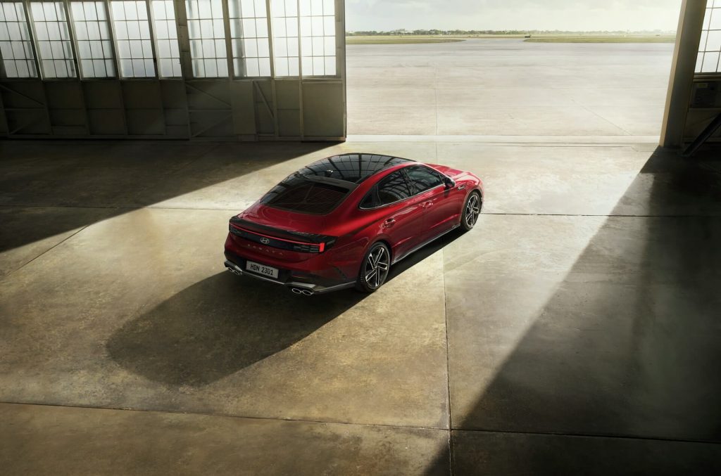 red sedan in aircraft hangar