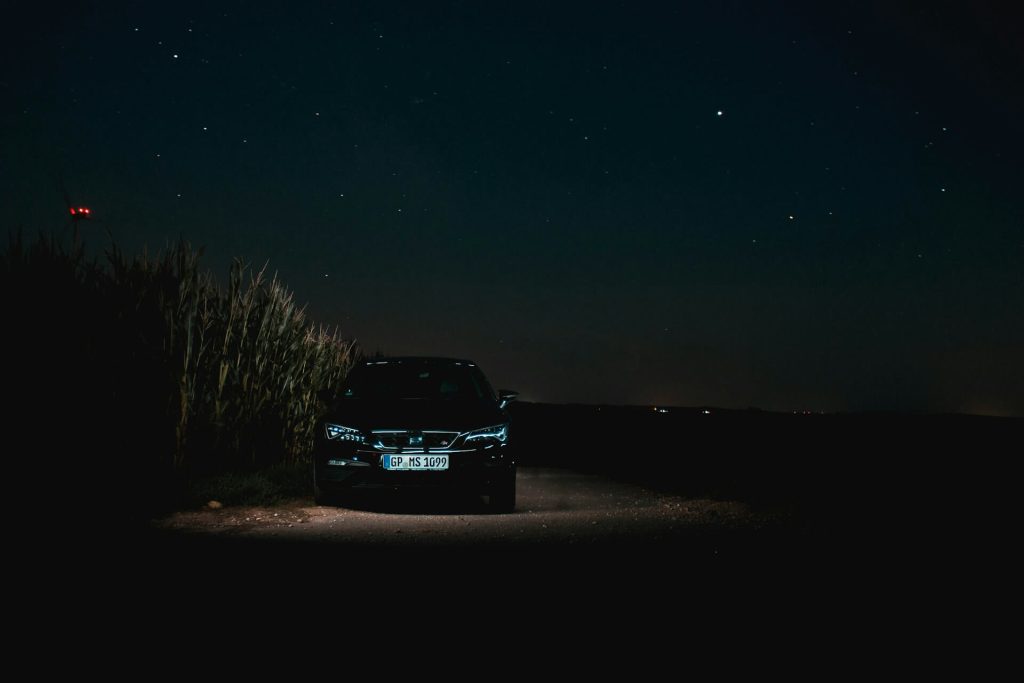 dark car under starry sky